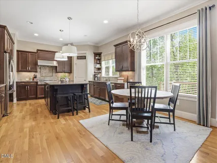 a living room with furniture a fireplace and a floor to ceiling window