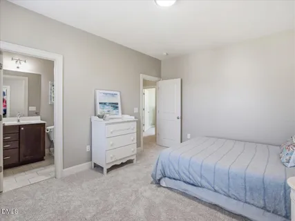 a view of a backyard with floor to ceiling windows and wooden fence