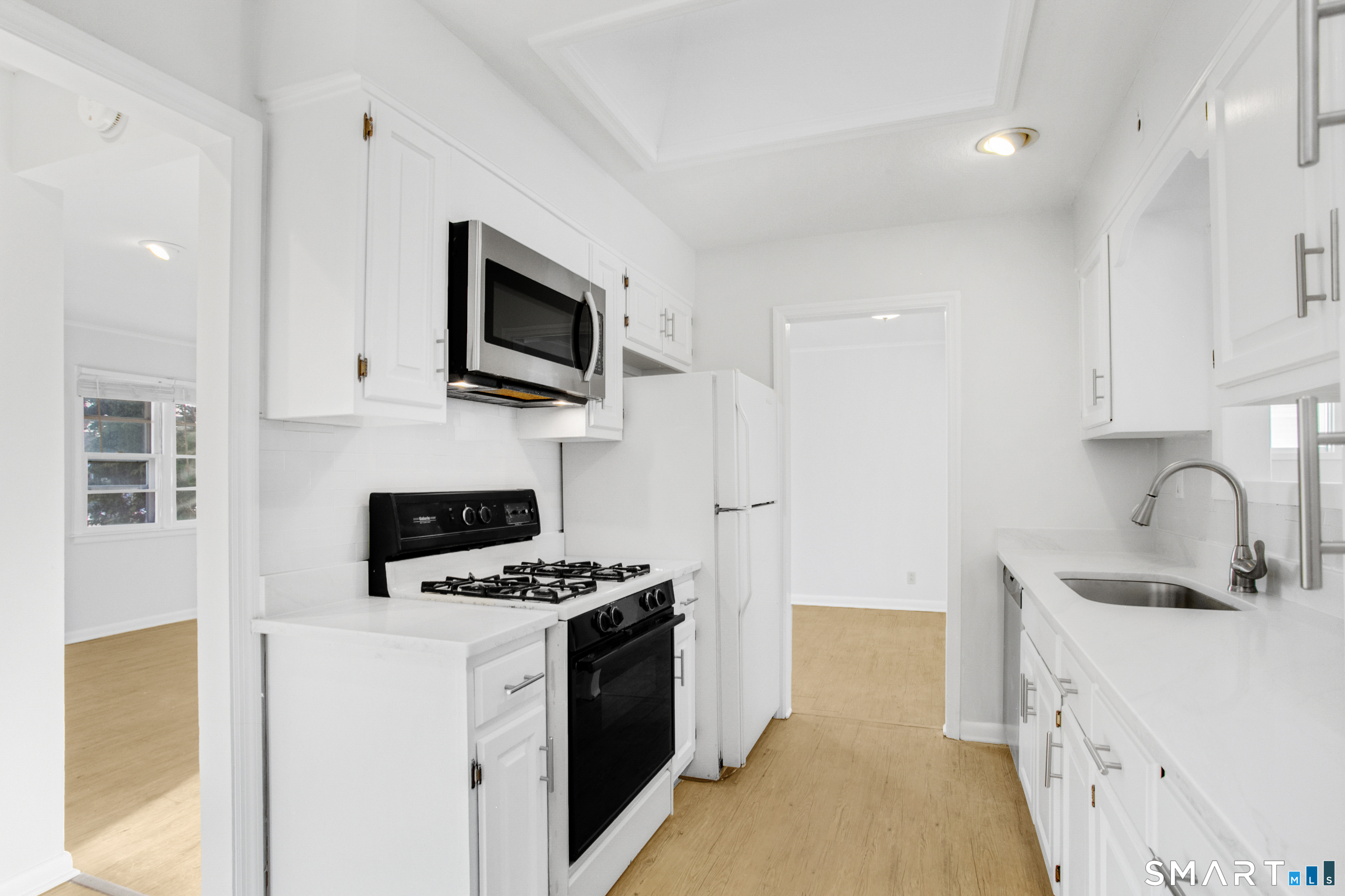 3432 Old Town Road Bridgeport, CT 06606 - Photo 11 of 27 a kitchen with stainless steel appliances a stove a sink and a microwave