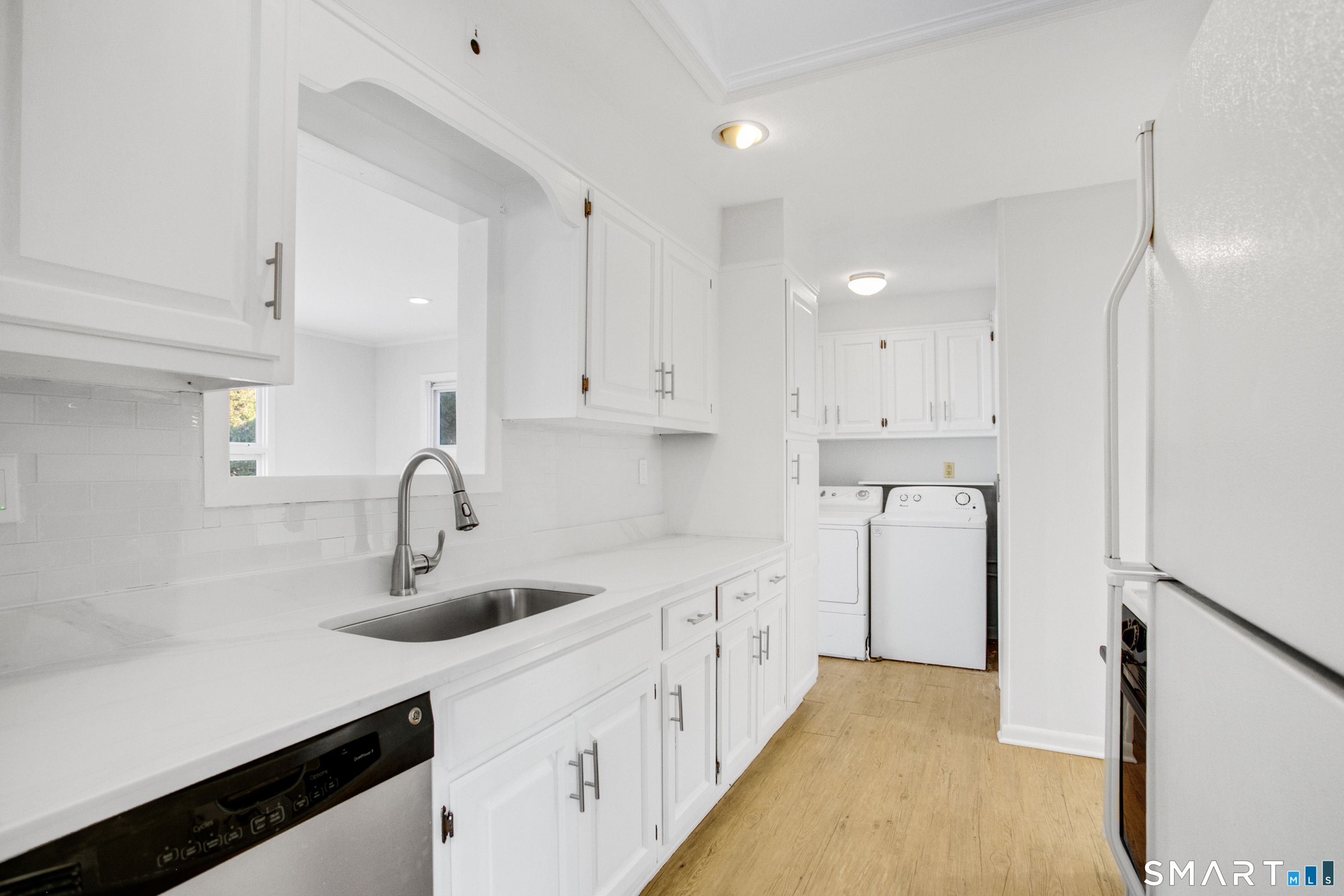 3432 Old Town Road Bridgeport, CT 06606 - Photo 12 of 27 a kitchen with white cabinets and sink