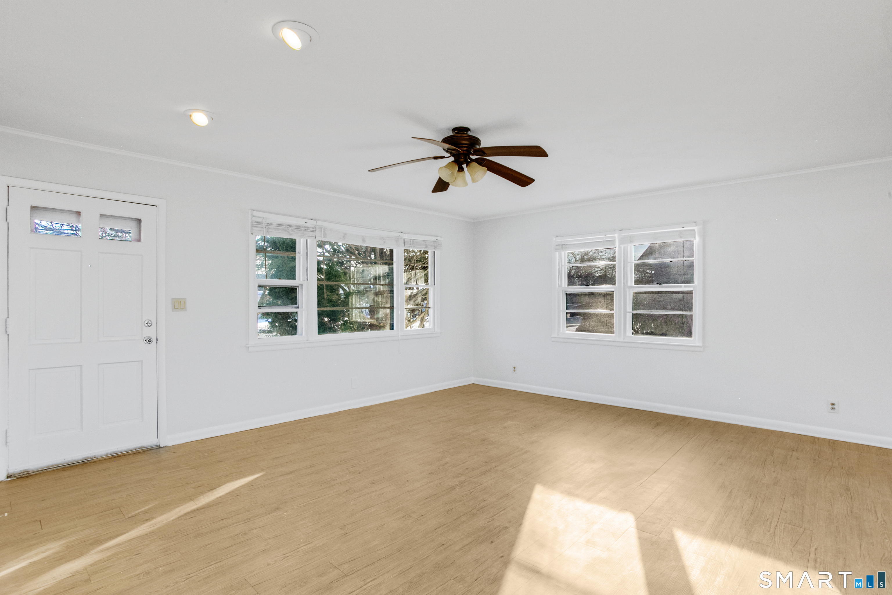 3432 Old Town Road Bridgeport, CT 06606 - Photo 5 of 27 a view of a big room with windows and ceiling fan