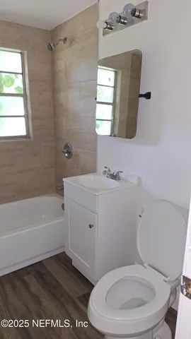 a white toilet sitting next to a bath tub shower