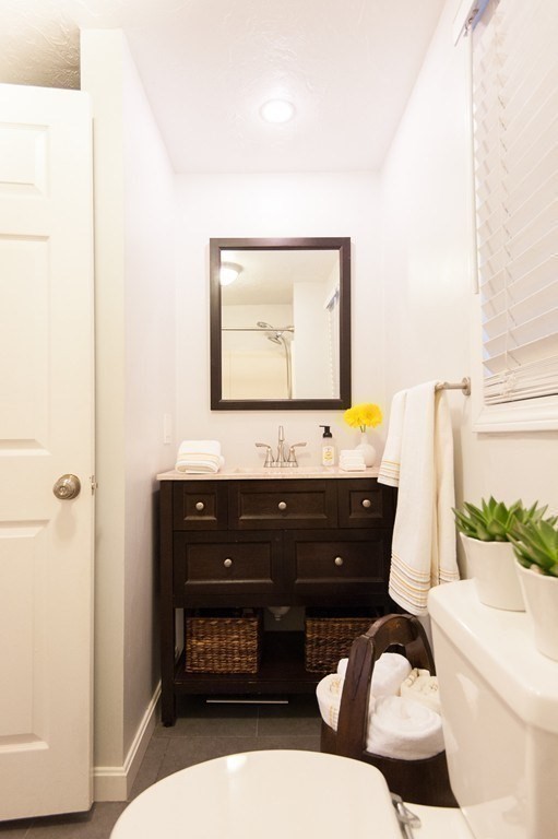 224 West Sixth Street, Unit 2 Boston, MA 02127 - Photo 11 of 18 a bathroom with a toilet a sink and mirror