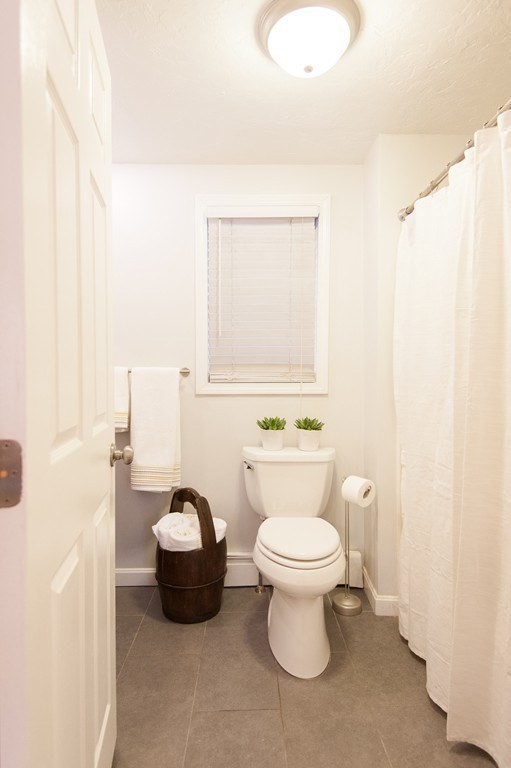 224 West Sixth Street, Unit 2 Boston, MA 02127 - Photo 12 of 18 a bathroom with a toilet sink and mirror