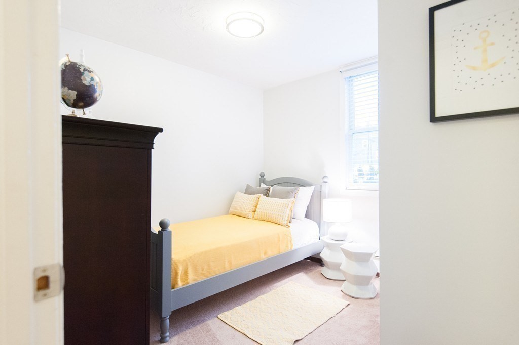 224 West Sixth Street, Unit 2 Boston, MA 02127 - Photo 15 of 18 a bedroom with a bed and wall painting