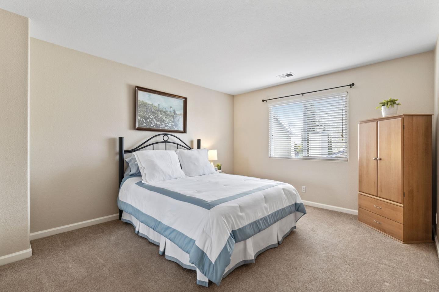 8975 Del Rio Circle Gilroy, CA 95020 - Photo 18 of 24 a bedroom with a bed and a window