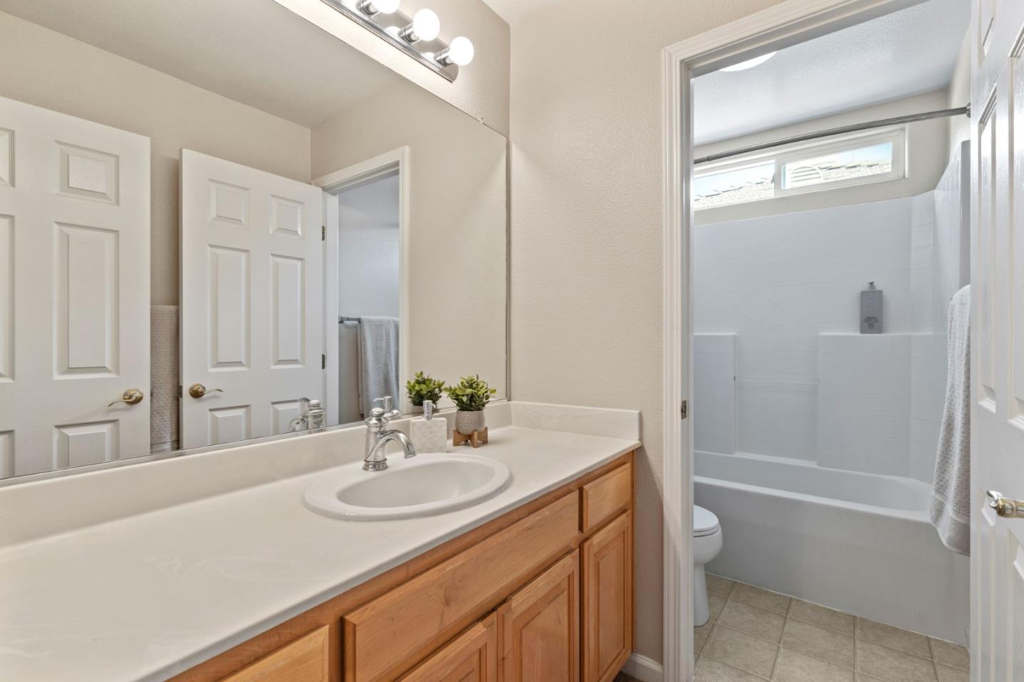 8975 Del Rio Circle Gilroy, CA 95020 - Photo 20 of 24 a bathroom with a granite countertop sink a toilet and shower