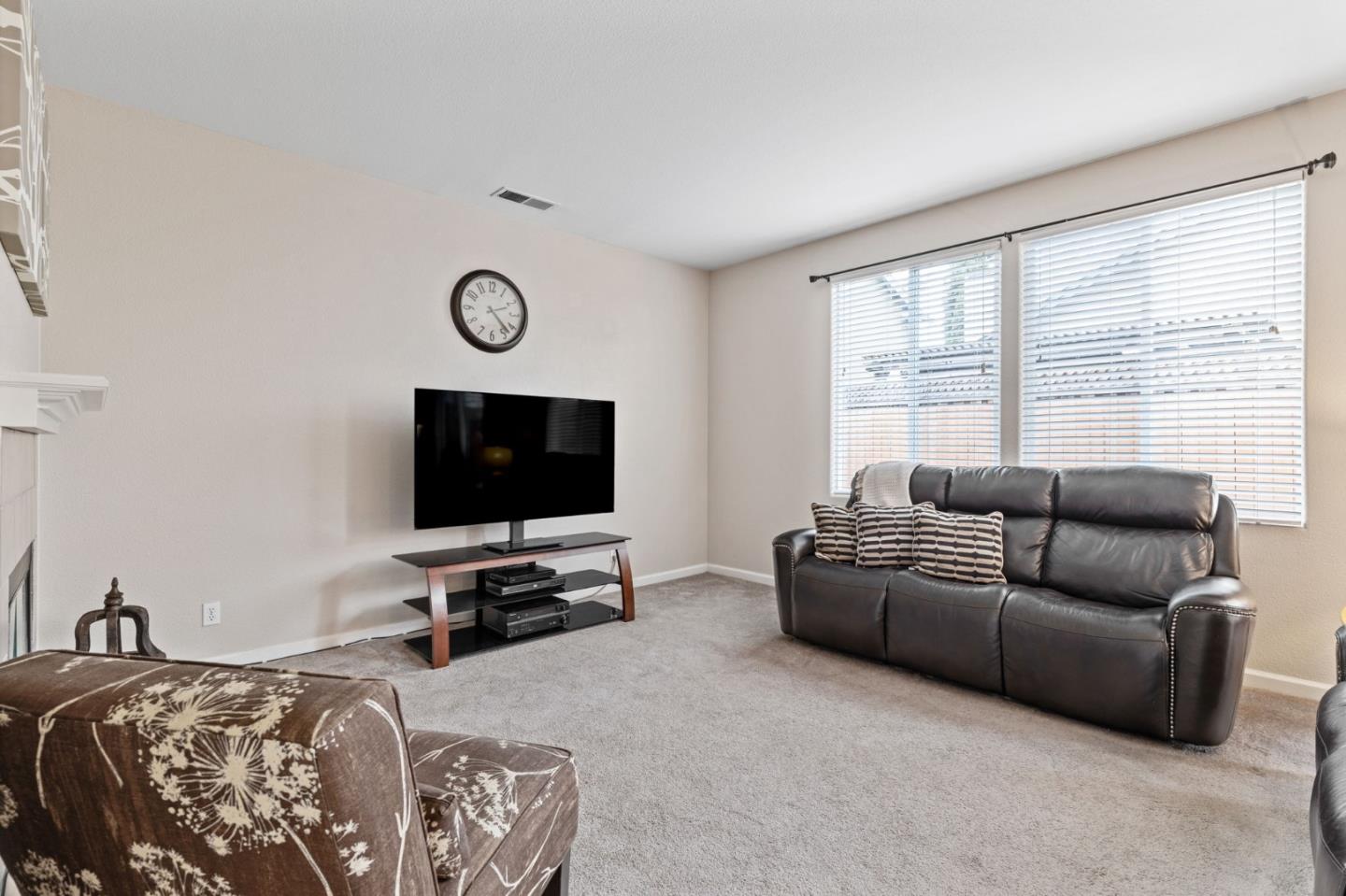 8975 Del Rio Circle Gilroy, CA 95020 - Photo 8 of 24 a living room with furniture and a flat screen tv