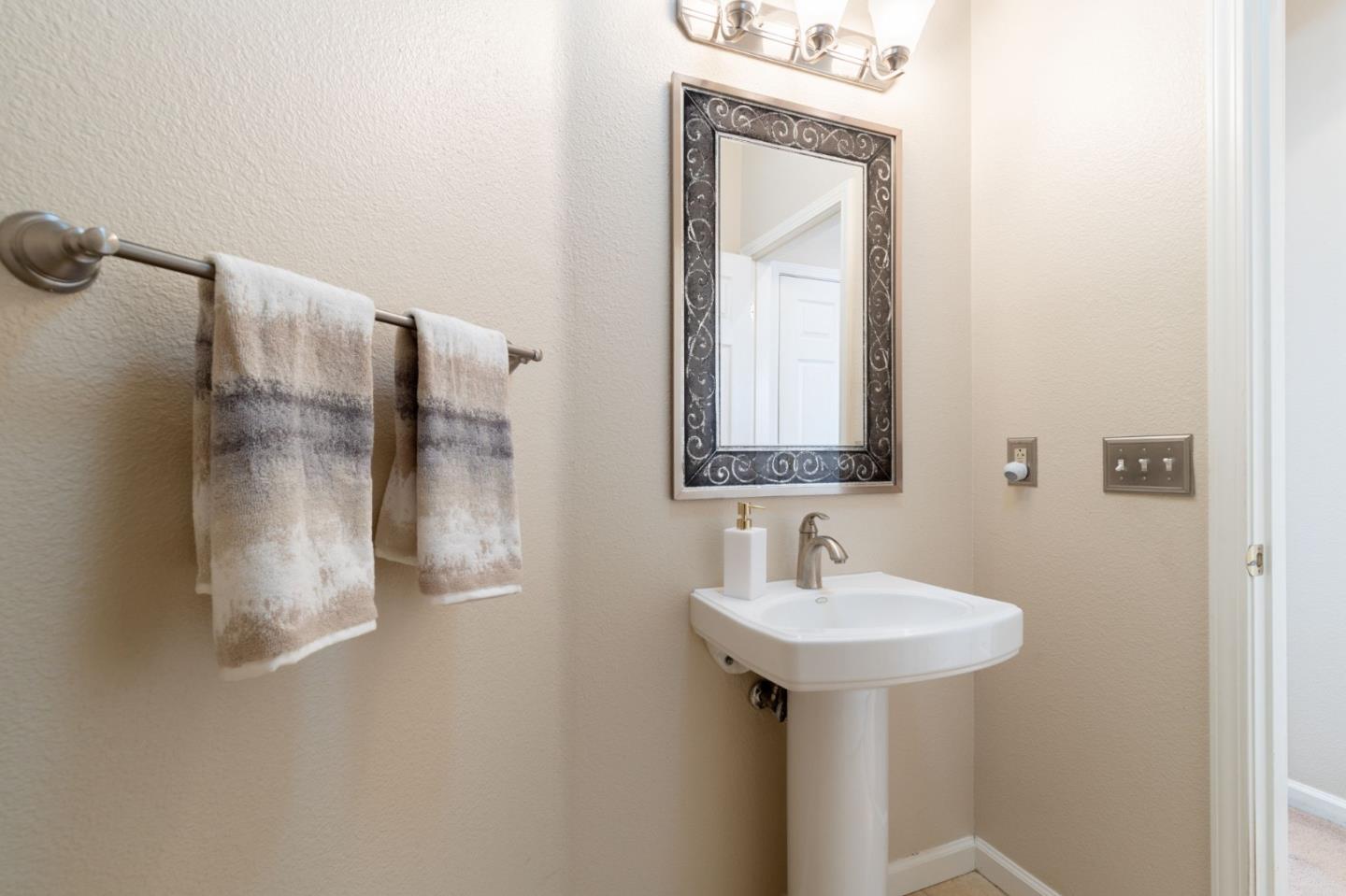 8975 Del Rio Circle Gilroy, CA 95020 - Photo 9 of 24 a bathroom with a sink and a mirror