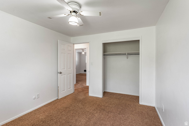 728 400 East Orem, UT 84097 - Photo 23 of 30 Neutral interior with brown carpet flooring, white walls, and a ceiling fan with integrated lighting