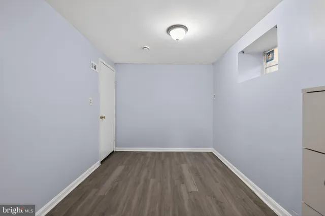 a view of room with wooden floor