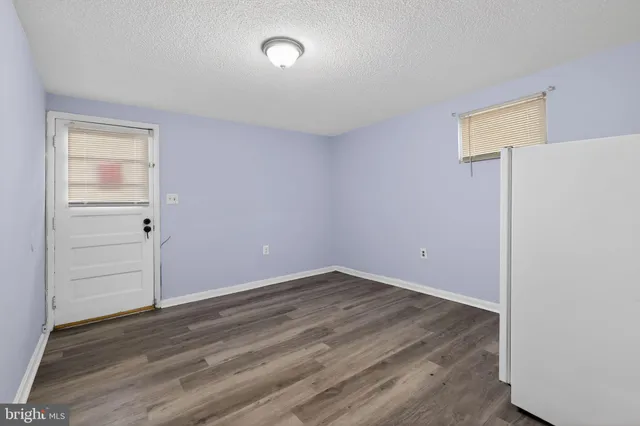an empty room with wooden floor and closet