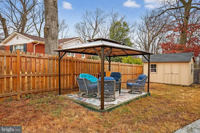 a view of a chairs and table in the backyard
