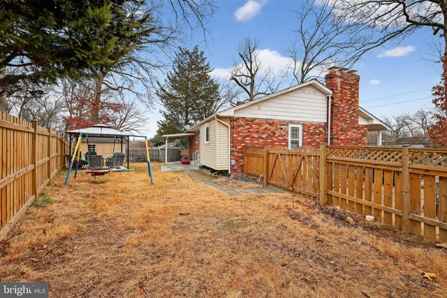 a view of a house with wooden fence