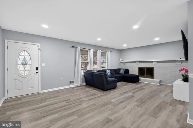 a living room with furniture and a fireplace