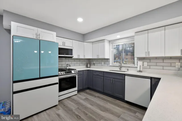 a kitchen with stainless steel appliances granite countertop a stove and a sink