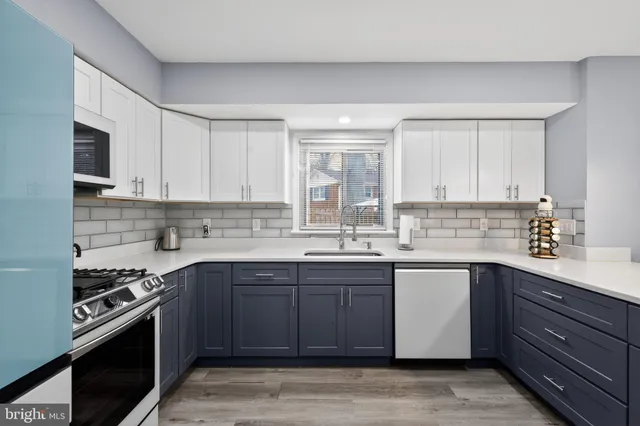 a kitchen with a sink stove and cabinets