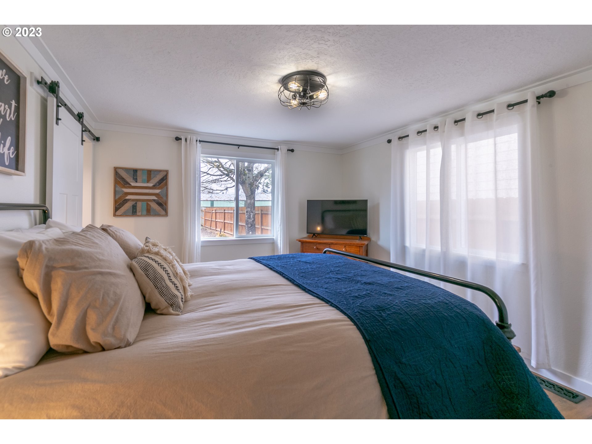 438 West Mary Street Lebanon, OR 97355 - Photo 33 of 33 a bedroom with a large bed and a tv