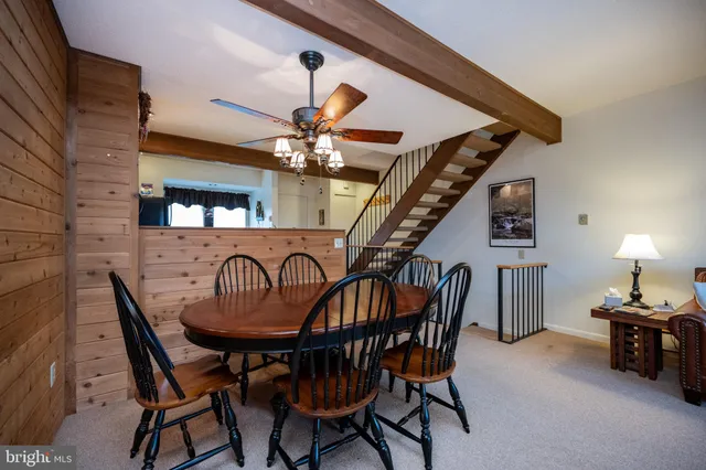 a dining room with furniture and chandelier