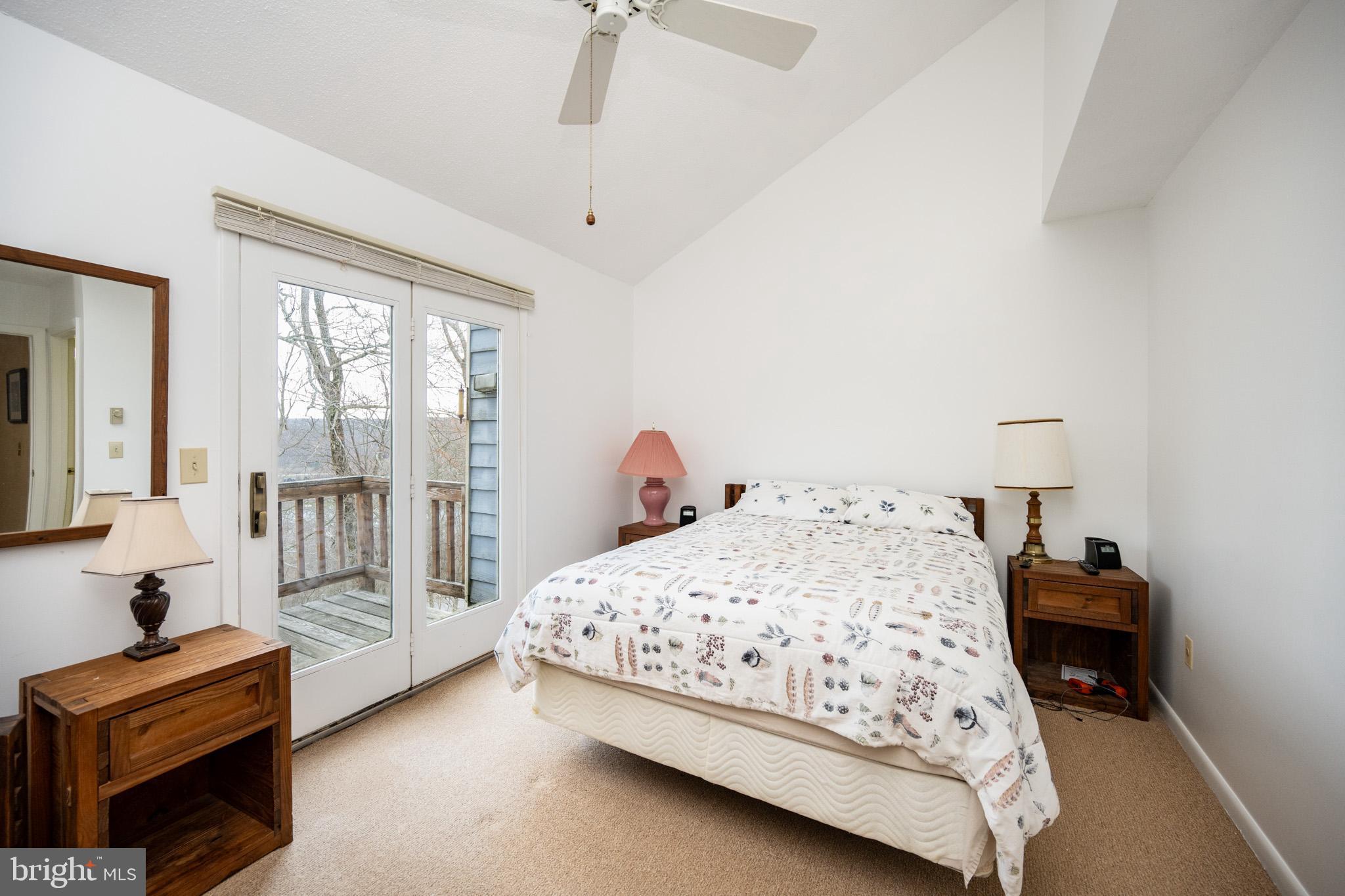 7 Winding Way, Unit 12B McHenry, MD 21541 - Photo 16 of 44 a bedroom with a bed and a chandelier