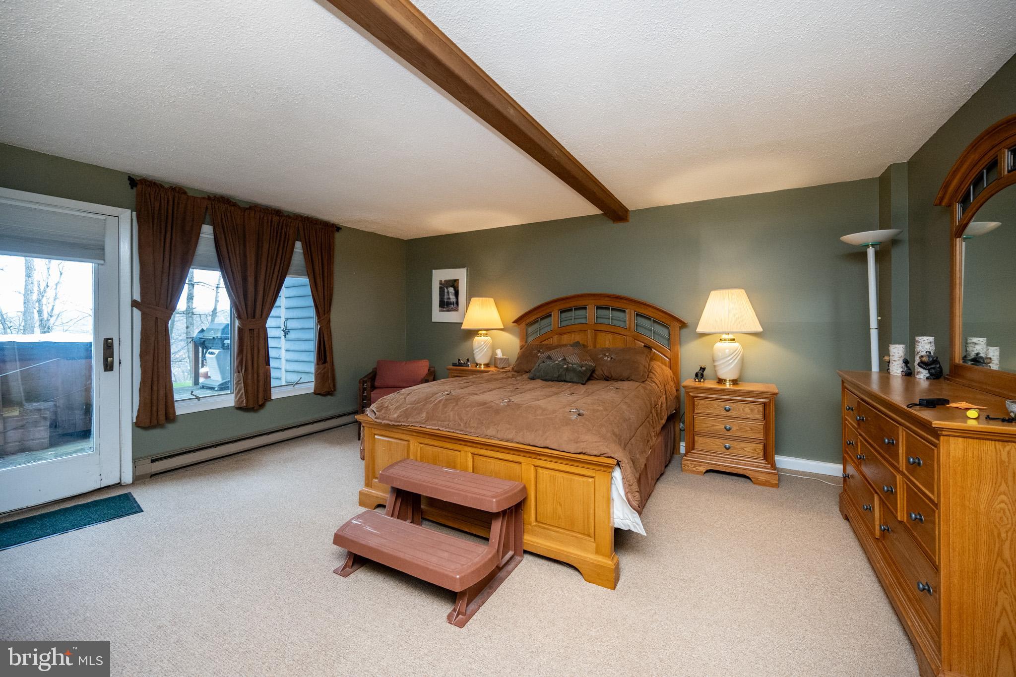 7 Winding Way, Unit 12B McHenry, MD 21541 - Photo 24 of 44 a bedroom with a bed and large window