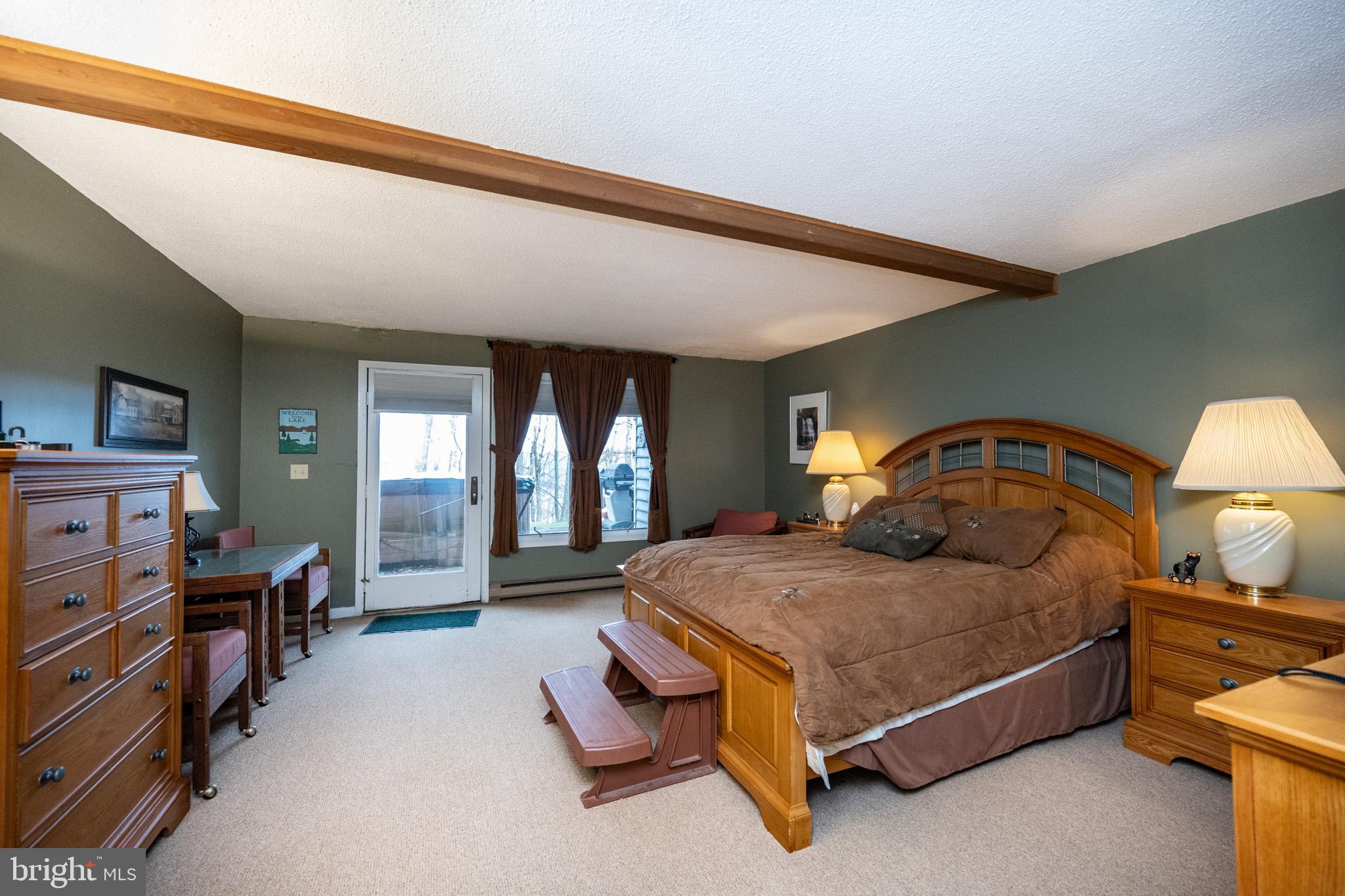 7 Winding Way, Unit 12B McHenry, MD 21541 - Photo 25 of 44 a bedroom with a bed and dresser with mirror