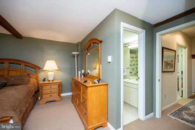 a bedroom with a bed and a mirror