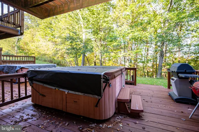 a view of a patio with table and chairs with wooden floor and fence