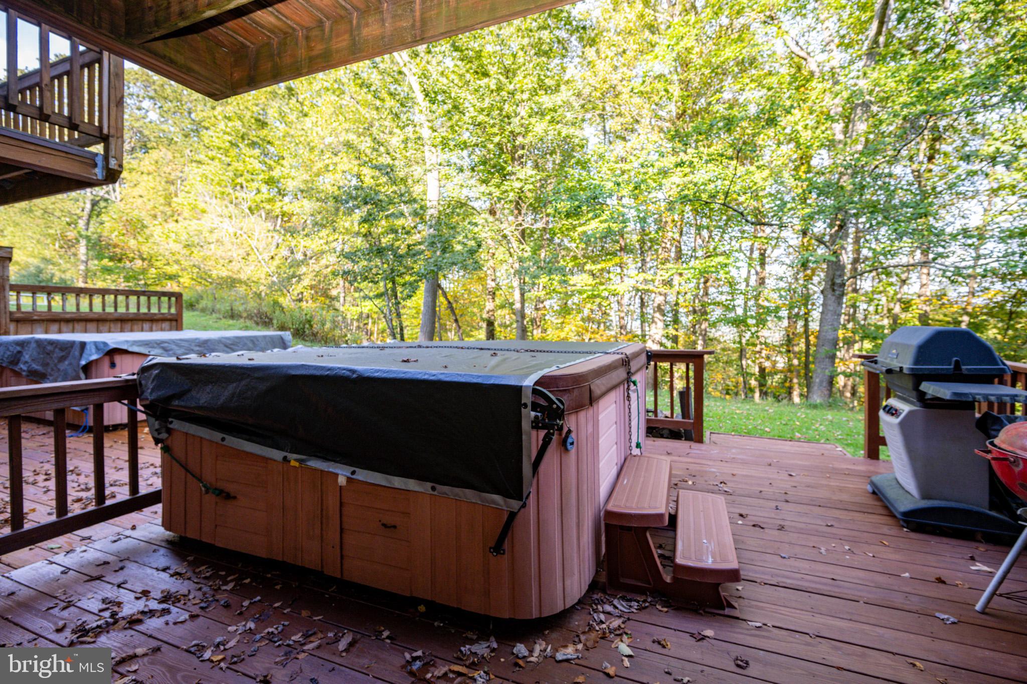 7 Winding Way, Unit 12B McHenry, MD 21541 - Photo 3 of 44 a view of a patio with table and chairs with wooden floor and fence
