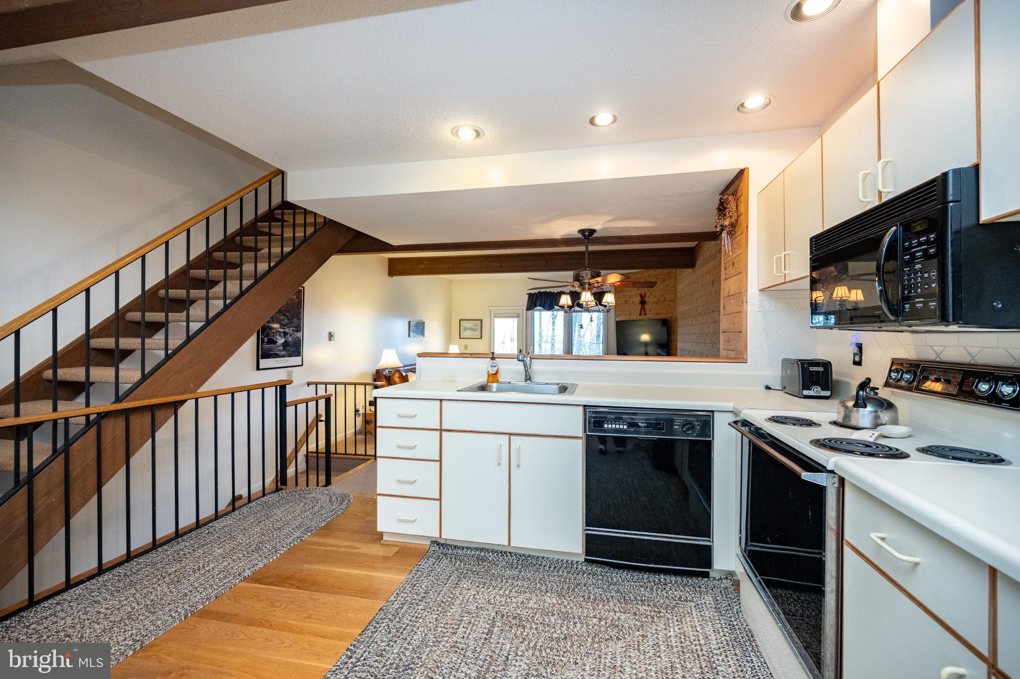 7 Winding Way, Unit 12B McHenry, MD 21541 - Photo 4 of 44 a kitchen with stainless steel appliances granite countertop a stove and a sink