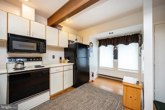 a kitchen with a sink stove and refrigerator