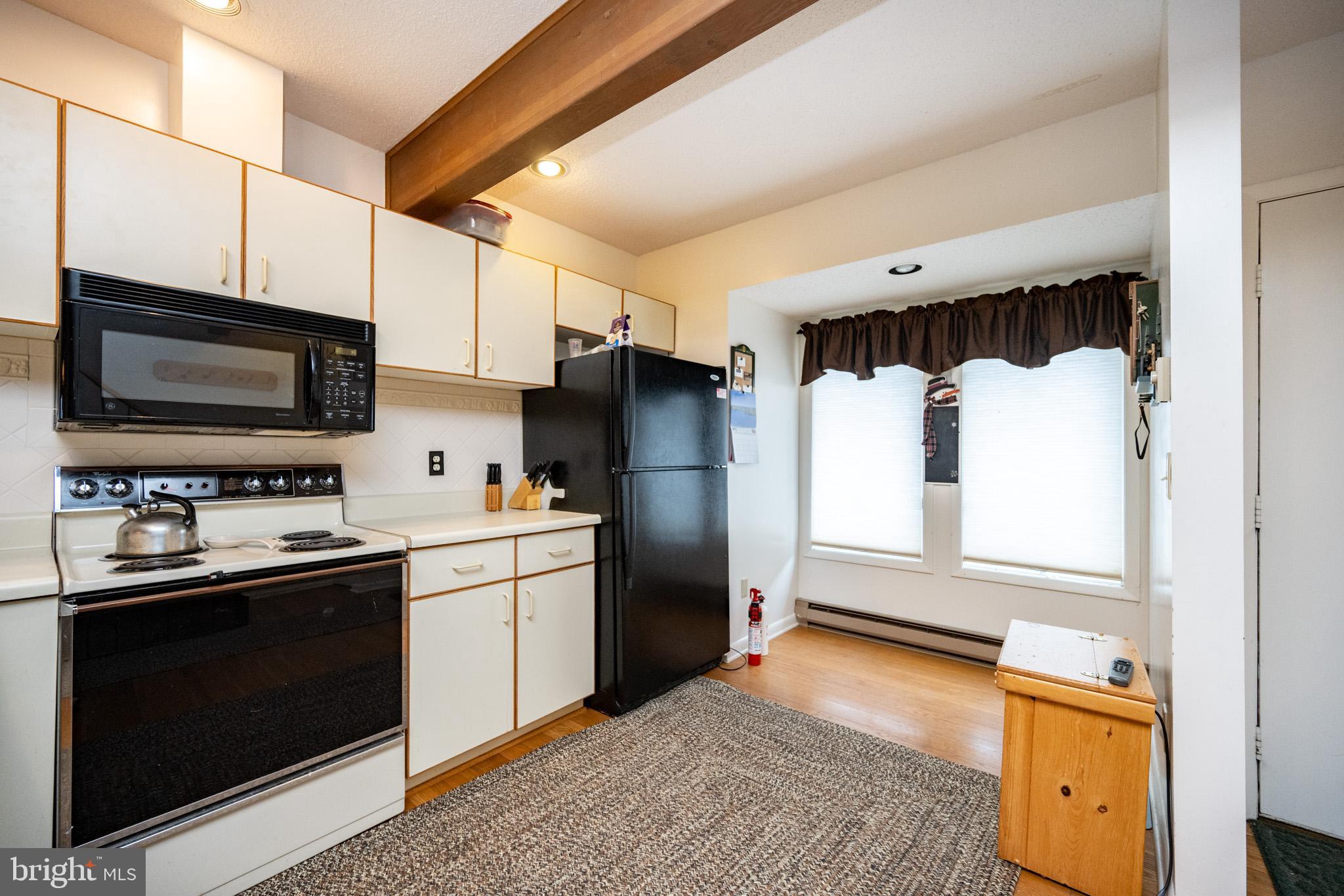 7 Winding Way, Unit 12B McHenry, MD 21541 - Photo 5 of 44 a kitchen with a sink stove and refrigerator