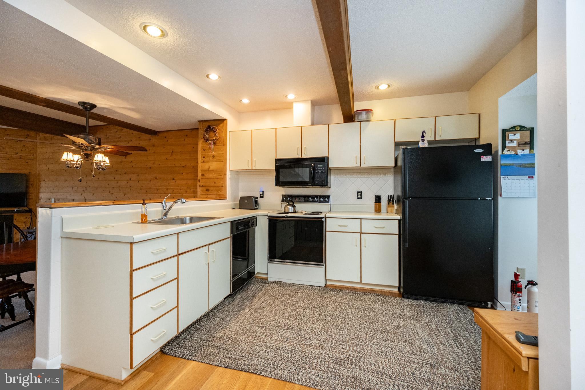 7 Winding Way, Unit 12B McHenry, MD 21541 - Photo 6 of 44 a kitchen with a sink stainless steel appliances and cabinets