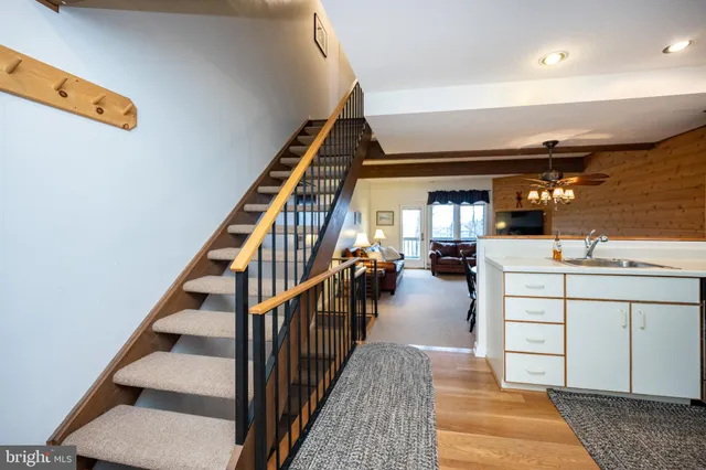 a hallway with white cabinets and white appliances