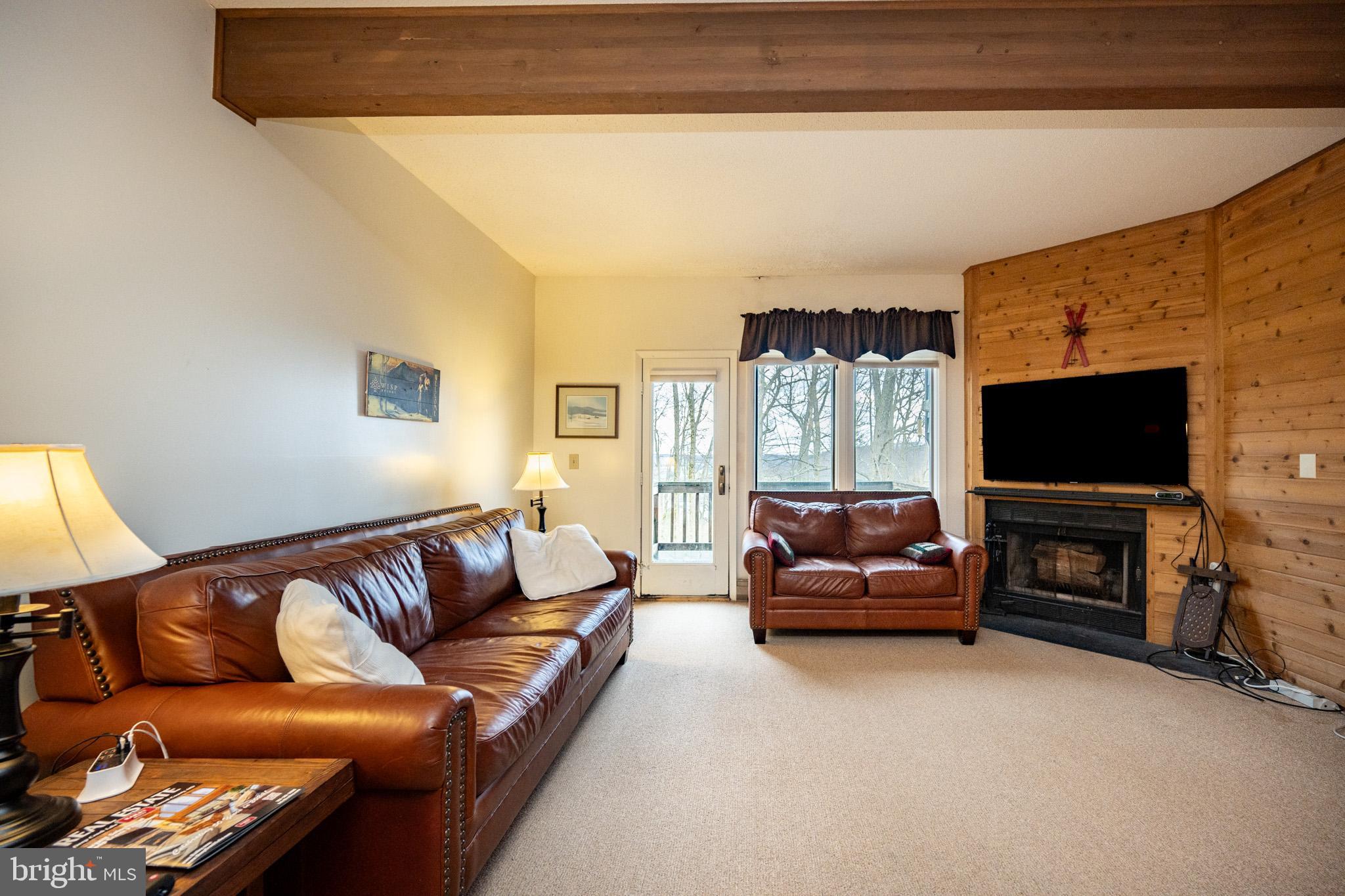 7 Winding Way, Unit 12B McHenry, MD 21541 - Photo 10 of 44 a living room with furniture a flat screen tv and a fireplace