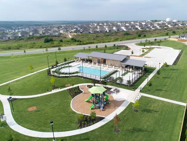 a view of swimming pool with outdoor seating and city view