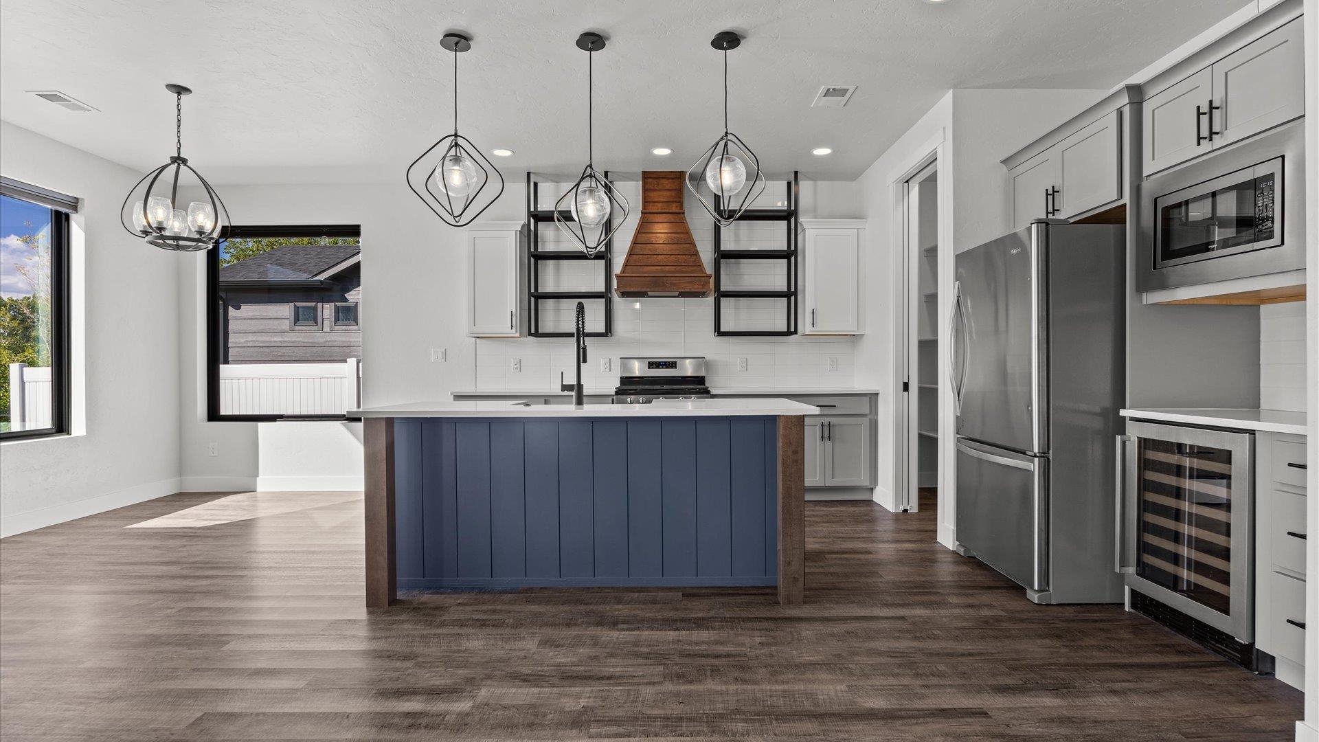745 Fairhaven Road Palisade, CO 81526 - Photo 12 of 33 a kitchen with stainless steel appliances granite countertop a refrigerator a oven and a wooden floor