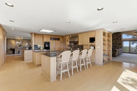 a large kitchen with a table and chairs
