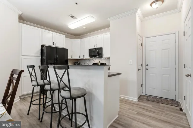 a kitchen with a refrigerator and a chair