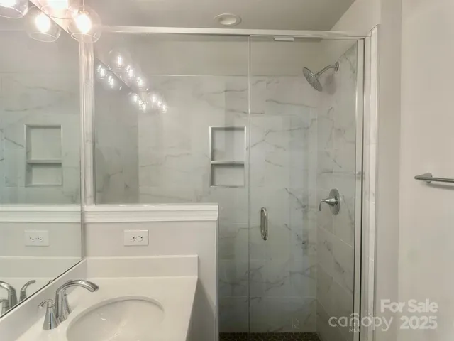 a bathroom with a shower a toilet and sink