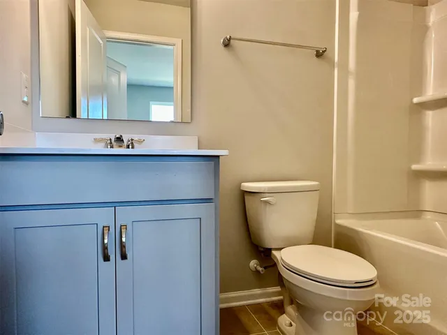 a bathroom with a toilet sink and shower