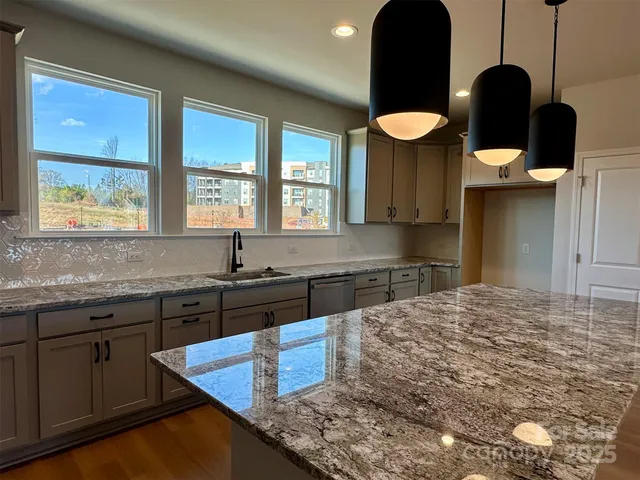 a kitchen with a sink cabinets and window