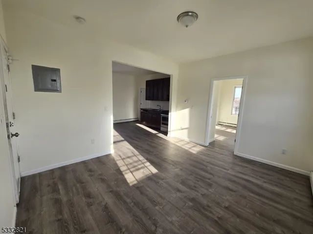 a view of a livingroom with wooden floor and a ceiling fan