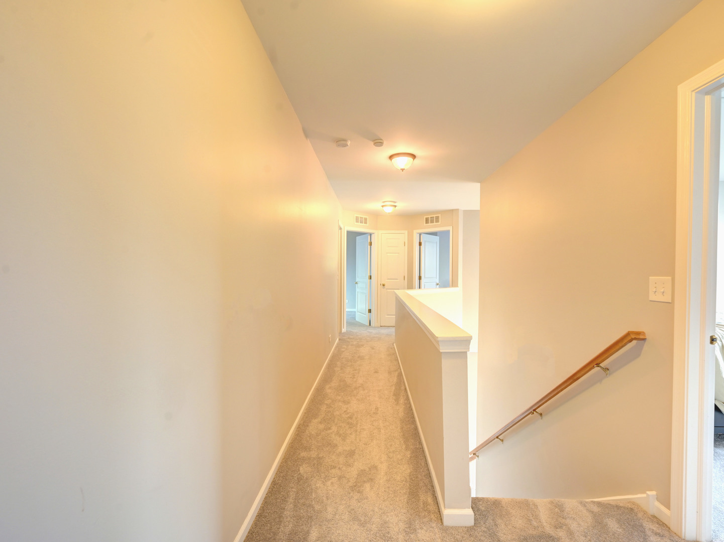 6 Forsythia Court Bolingbrook, IL 60490 - Photo 16 of 28 a view of a hallway with wooden floor and staircase