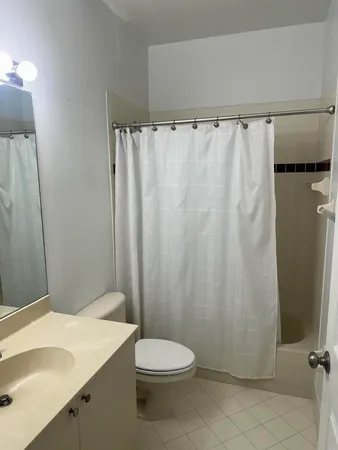 a bathroom with a toilet a sink and a shower