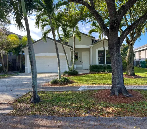 a view of a house with a tree in the yard