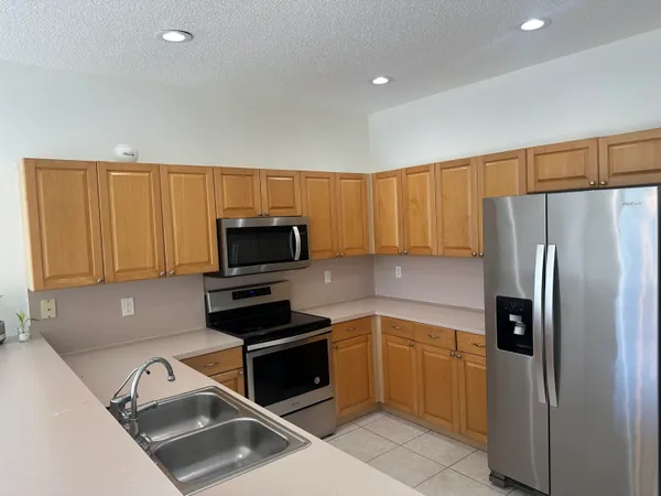 a kitchen with a refrigerator sink and microwave