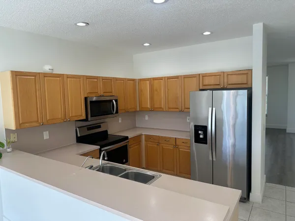 a kitchen with a refrigerator and a sink