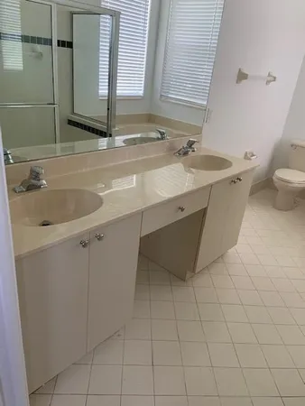 a spacious bathroom with a granite countertop sink toilet and bathtub