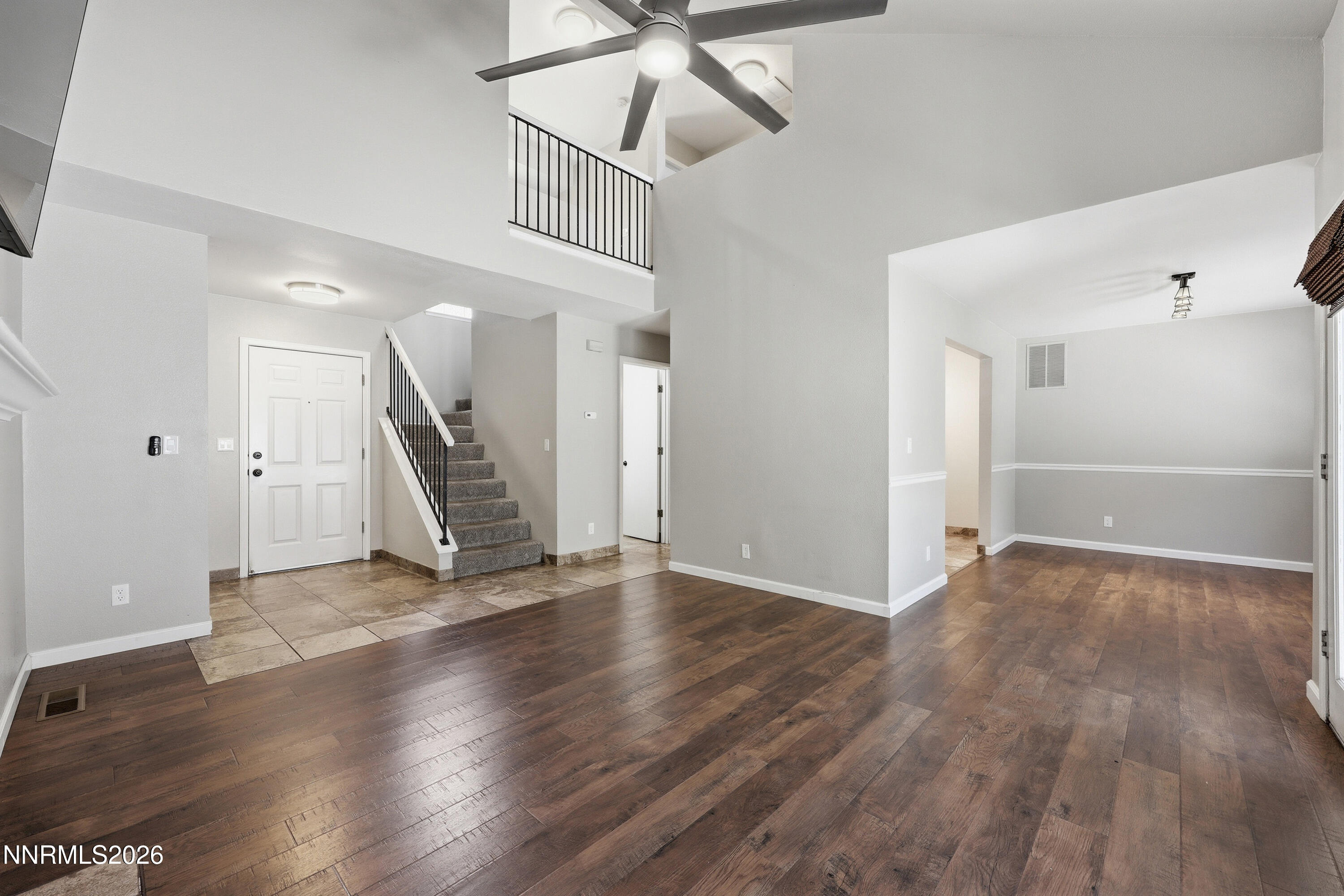 1899 Tuolumne Drive Reno, NV 89523 - Photo 8 of 44 an empty room with wooden floor fan and windows